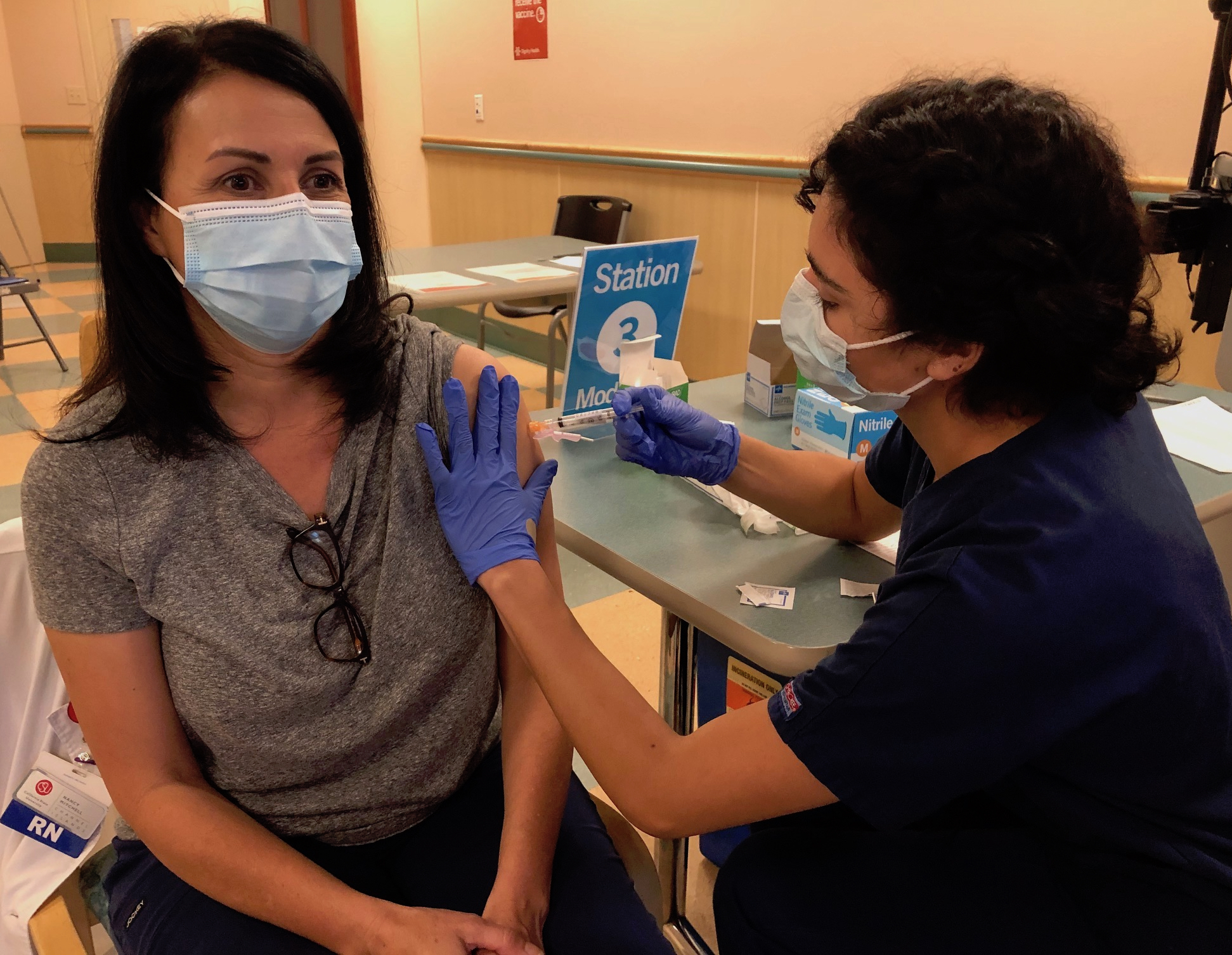 CSUCI Nursing student Carolina Torres gives a COVID-19 vaccine to Nursing faculty member.