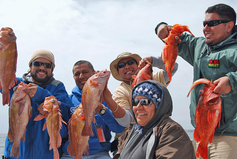 In an example of abundance, five anglers happily hold up the fish they have just caught.