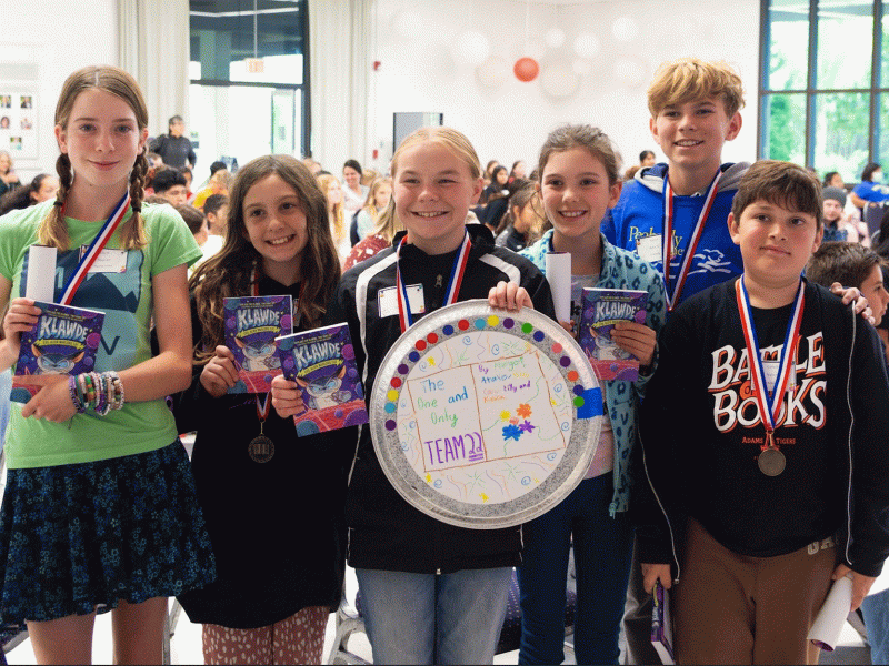 Members of The One and Only Team 22 pose proudly with their medals and books, following their first place win, (Courtesy photo)