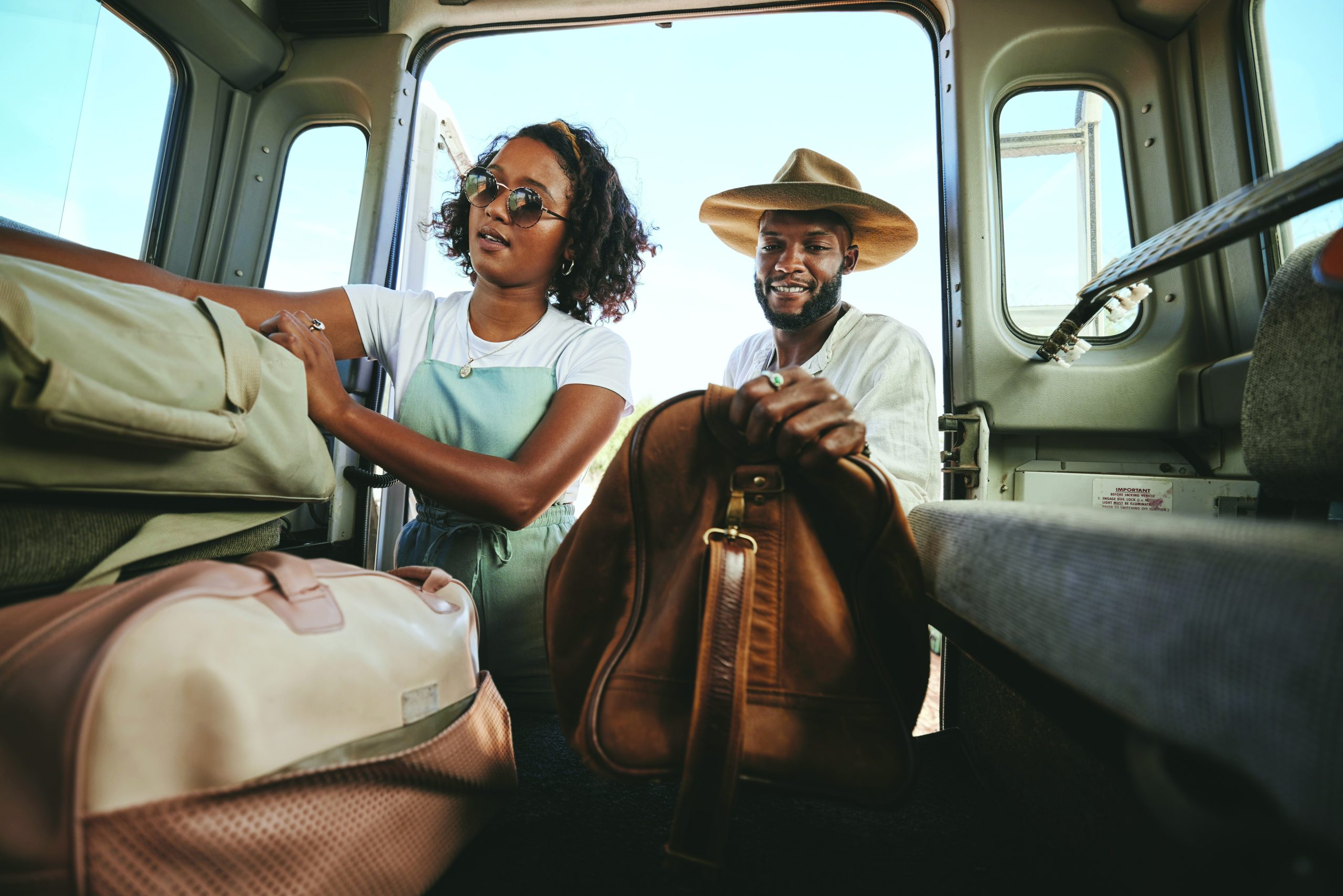 Couple loading their car with their bags and luggage for a road trip or adventure