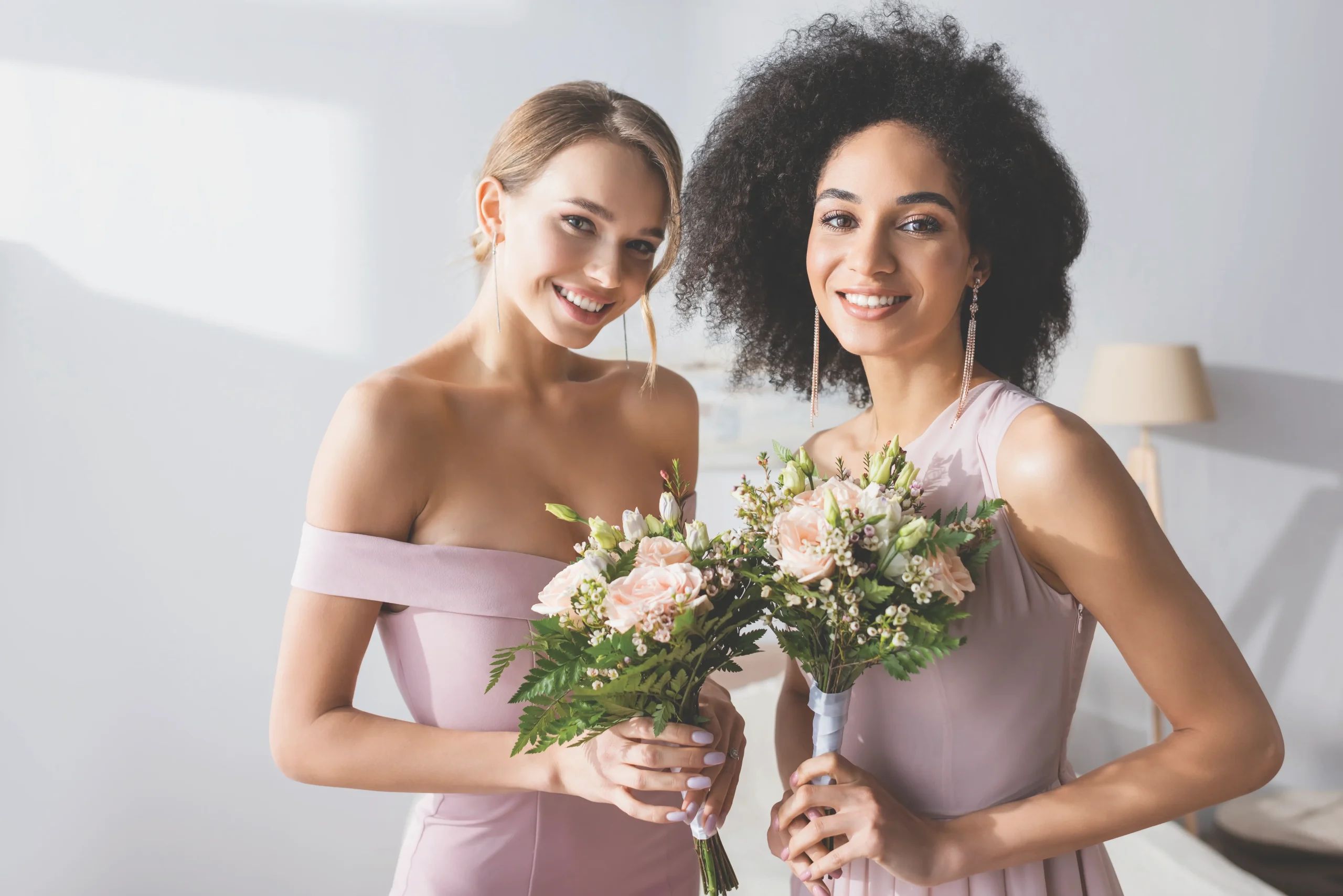 Bridesmaids glowing with joy and beautiful bouquets.