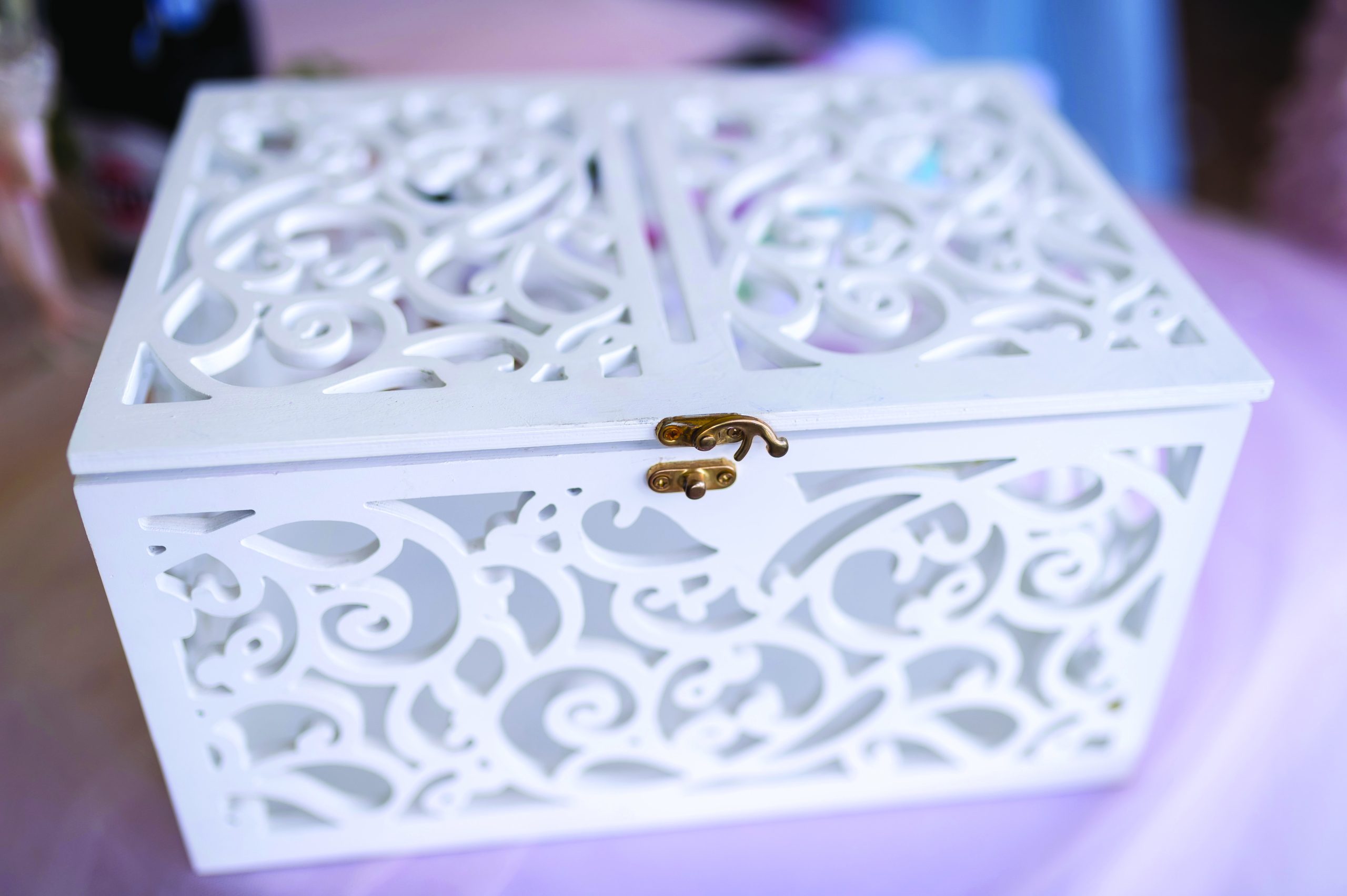 Elegant white decorative box with intricate cut-out design.