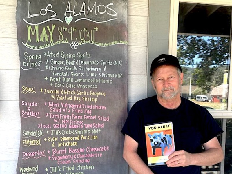 Author Jamie Baker stands outside Full of Life Flatbread in Los Alamos, where he treated himself to Sunday dinners after meeting his weekly word-count goal while crafting his “You Ate It" novel.