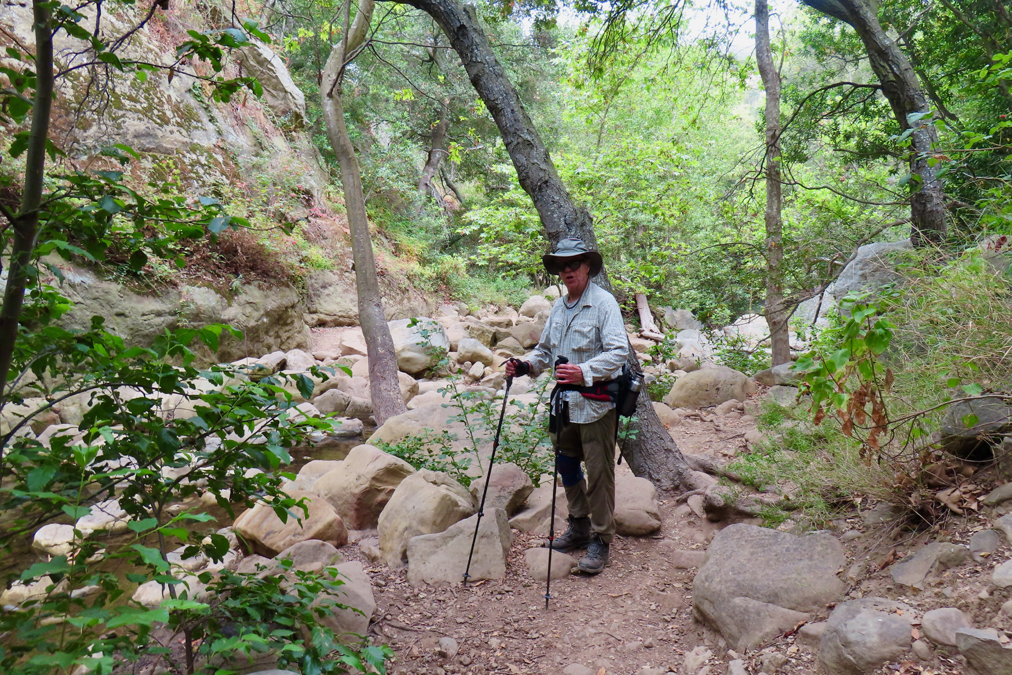 Note this Rattlesnake Canyon hiker's apparel — a wide-brim hat, a long-sleeve shirt over a T-shirt, heavy hiking boots, and sunglasses.