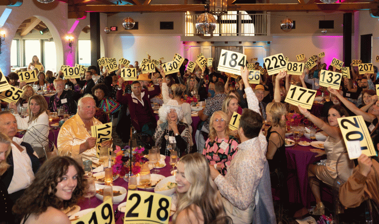 Attendees raise black and yellow bidding signs at gala to support Santa Barbara Humane animals and programs. (Courtesy Photo)