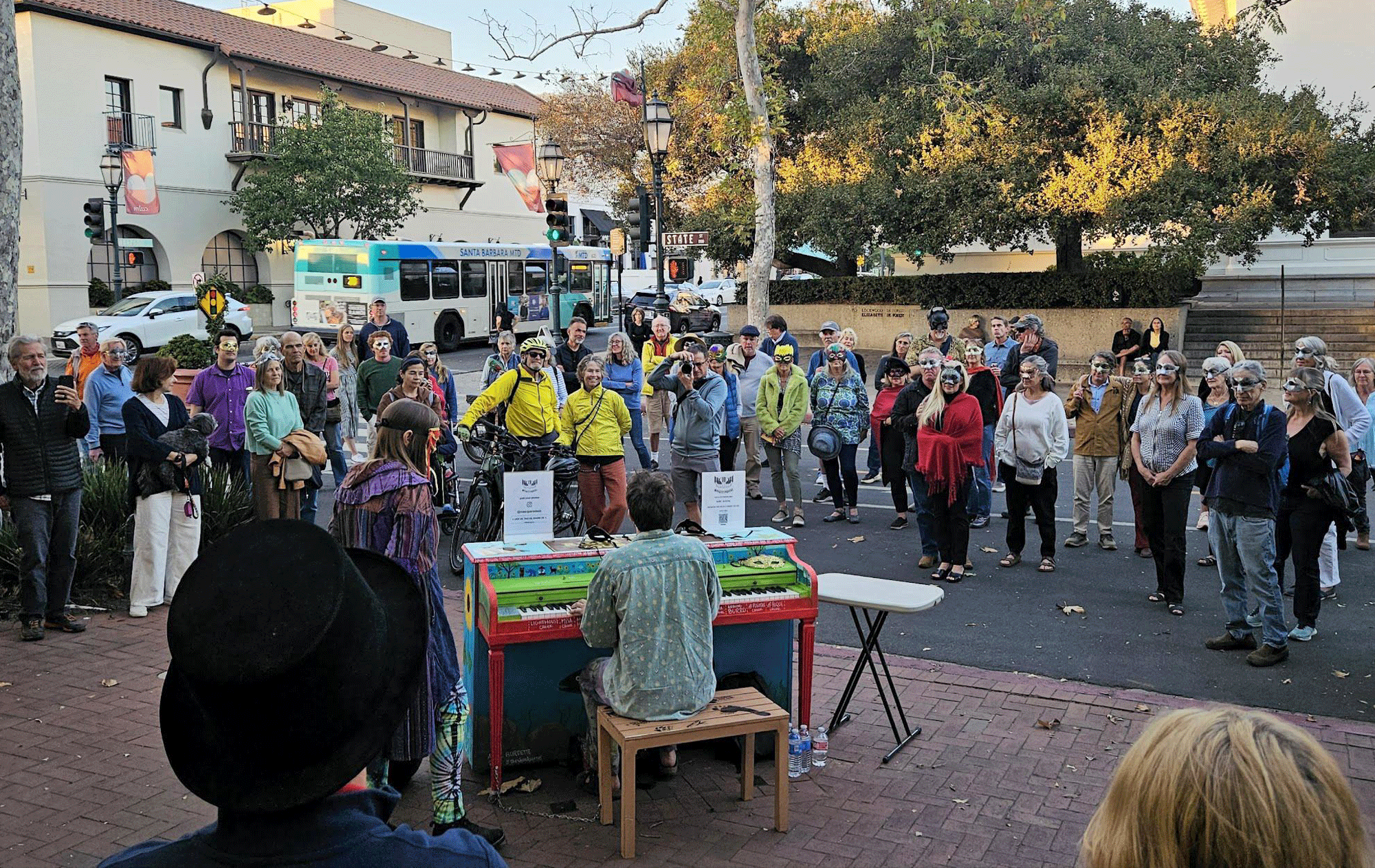 An audience gathers around to hear piano performers at an earlier Masq(p)arade show on State Street. (Courtesy photo)