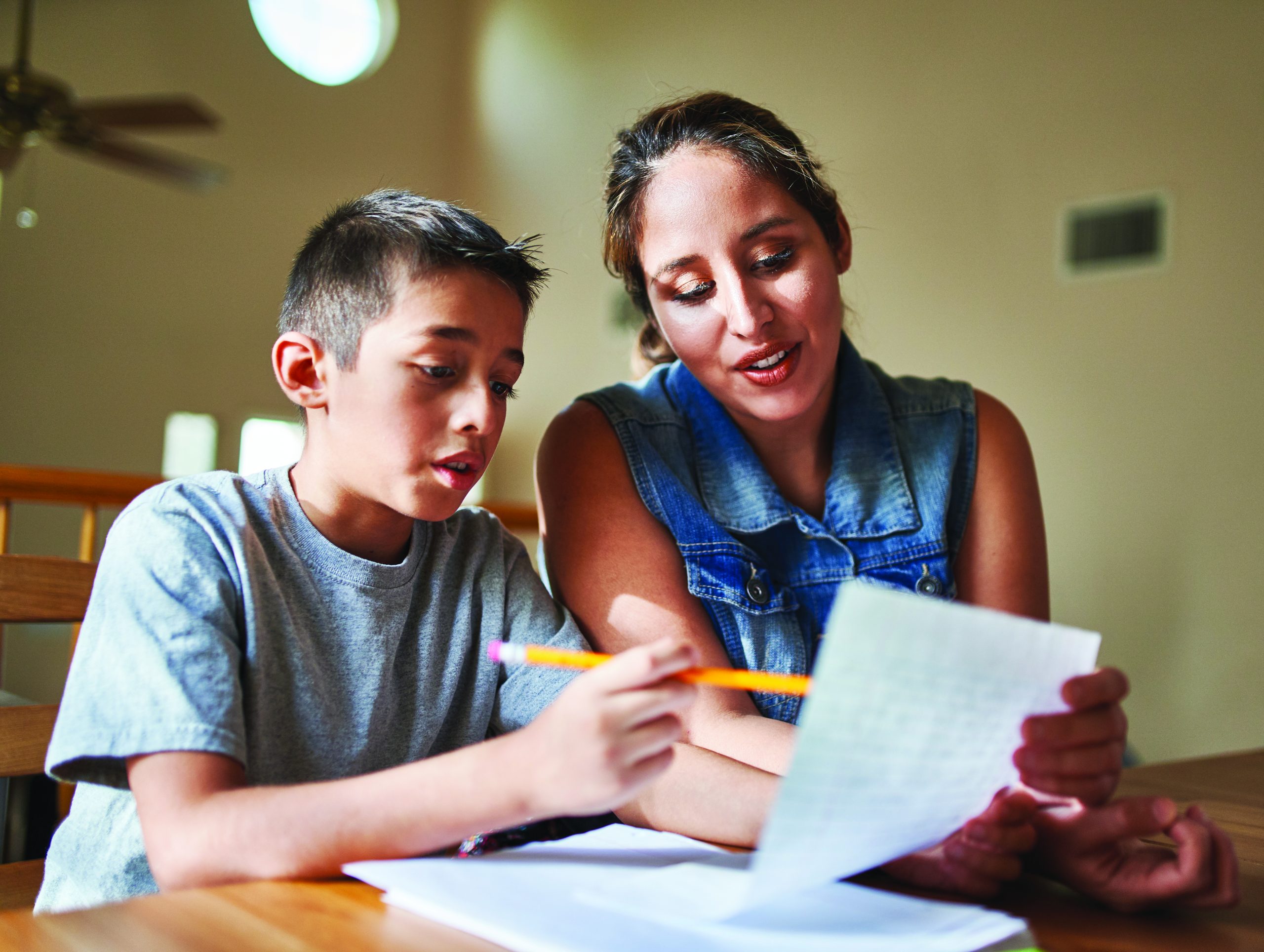 mother helping son with homework