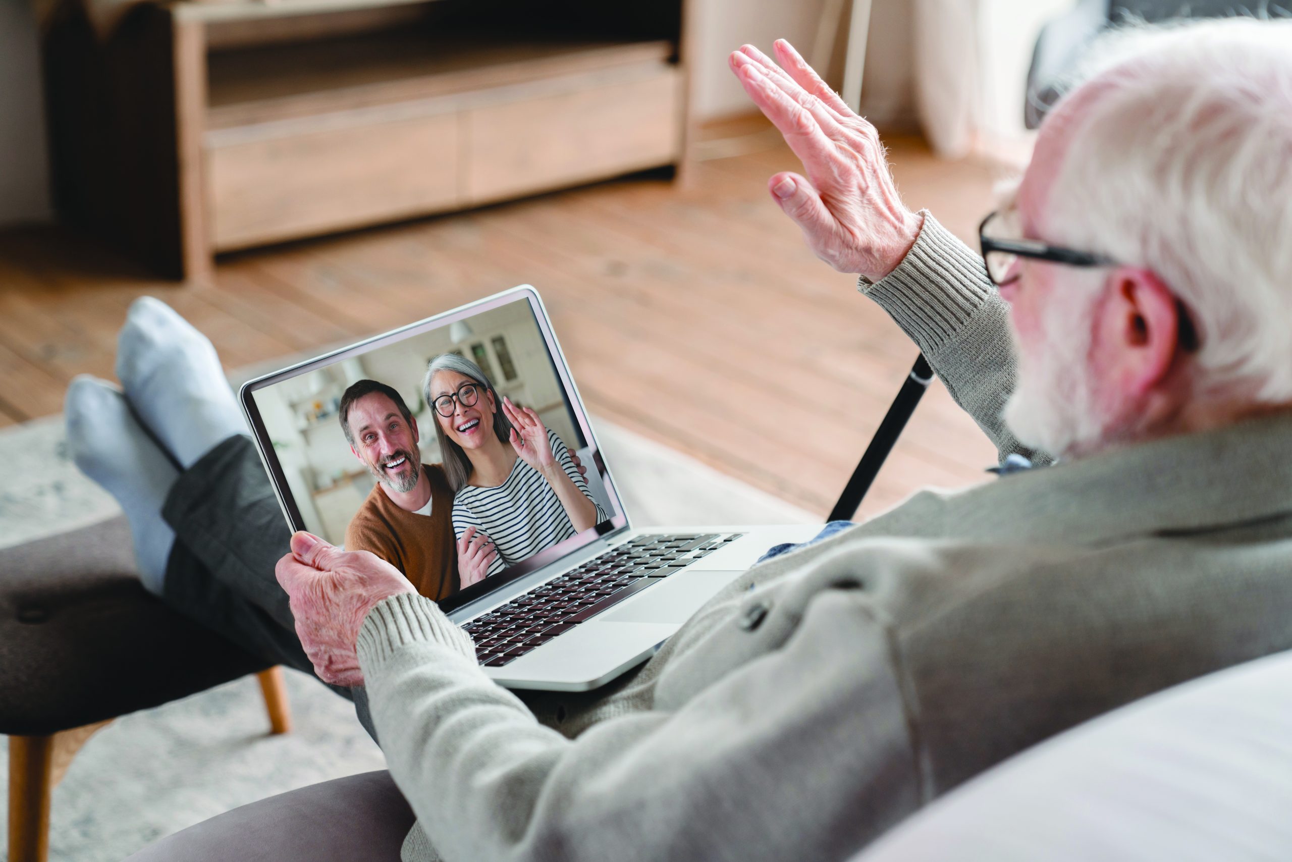 Old elderly pensioner man grandfather having videocall conversation meeting virtual conference with his family, grandchildren, children on digital tablet online remotely on distance