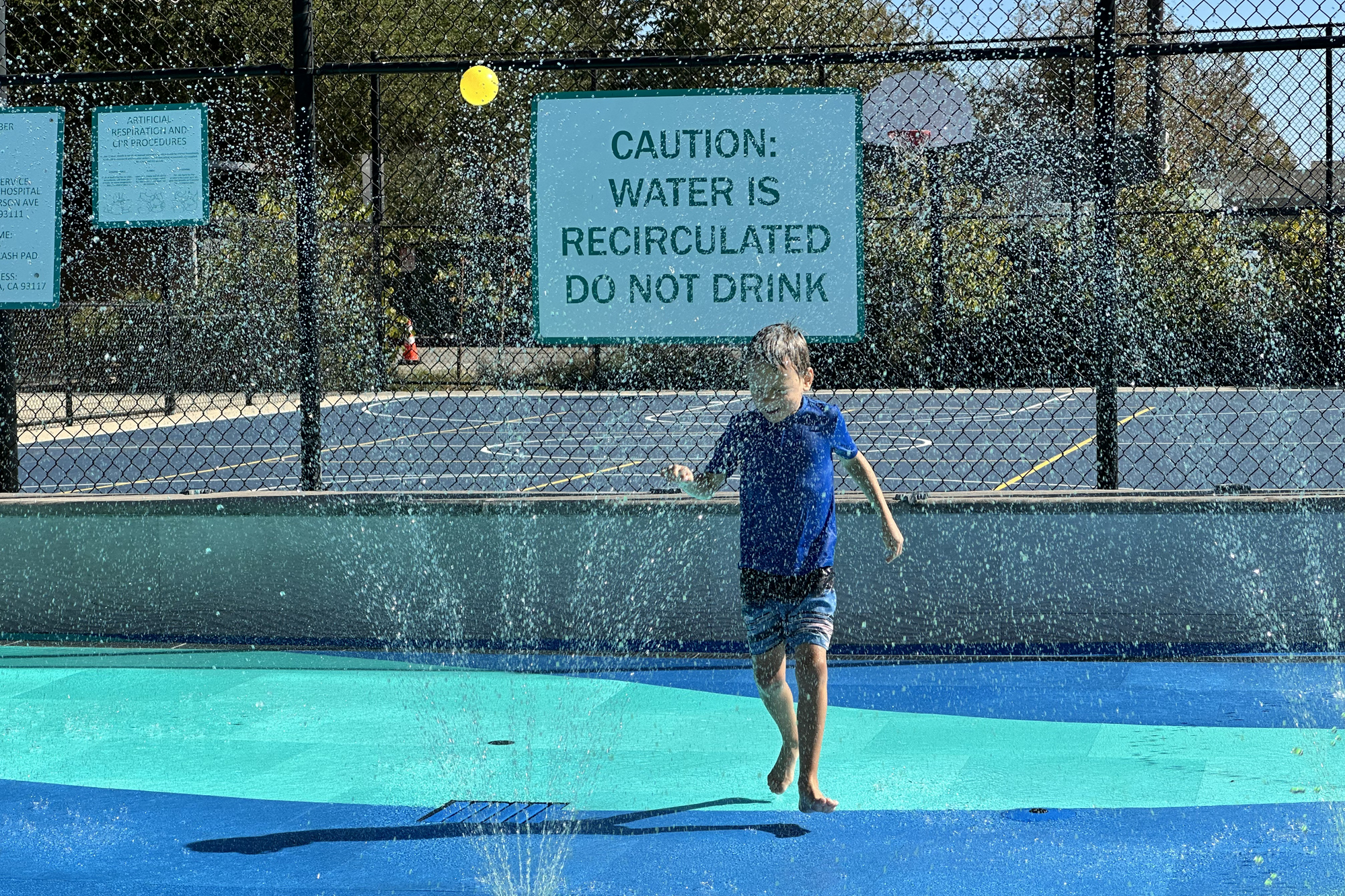 Thomas Uretz, 5, runs through the jets at the splash pad at Jonny D. Wallis Neighborhood Park in Old Town Goleta ahead of the splash pad's final day of the season.