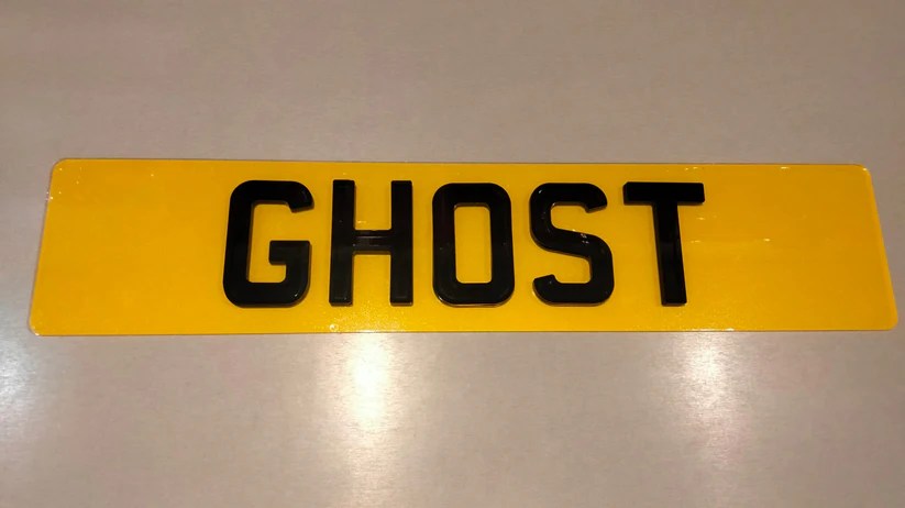 Car license plate featuring Ghost1 design with ghostly elements.