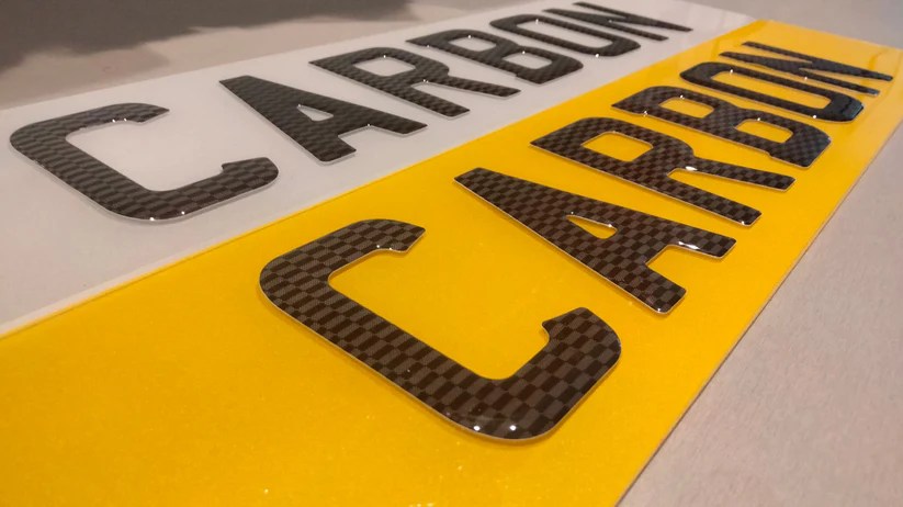Carbon fiber-style custom car number plate design.