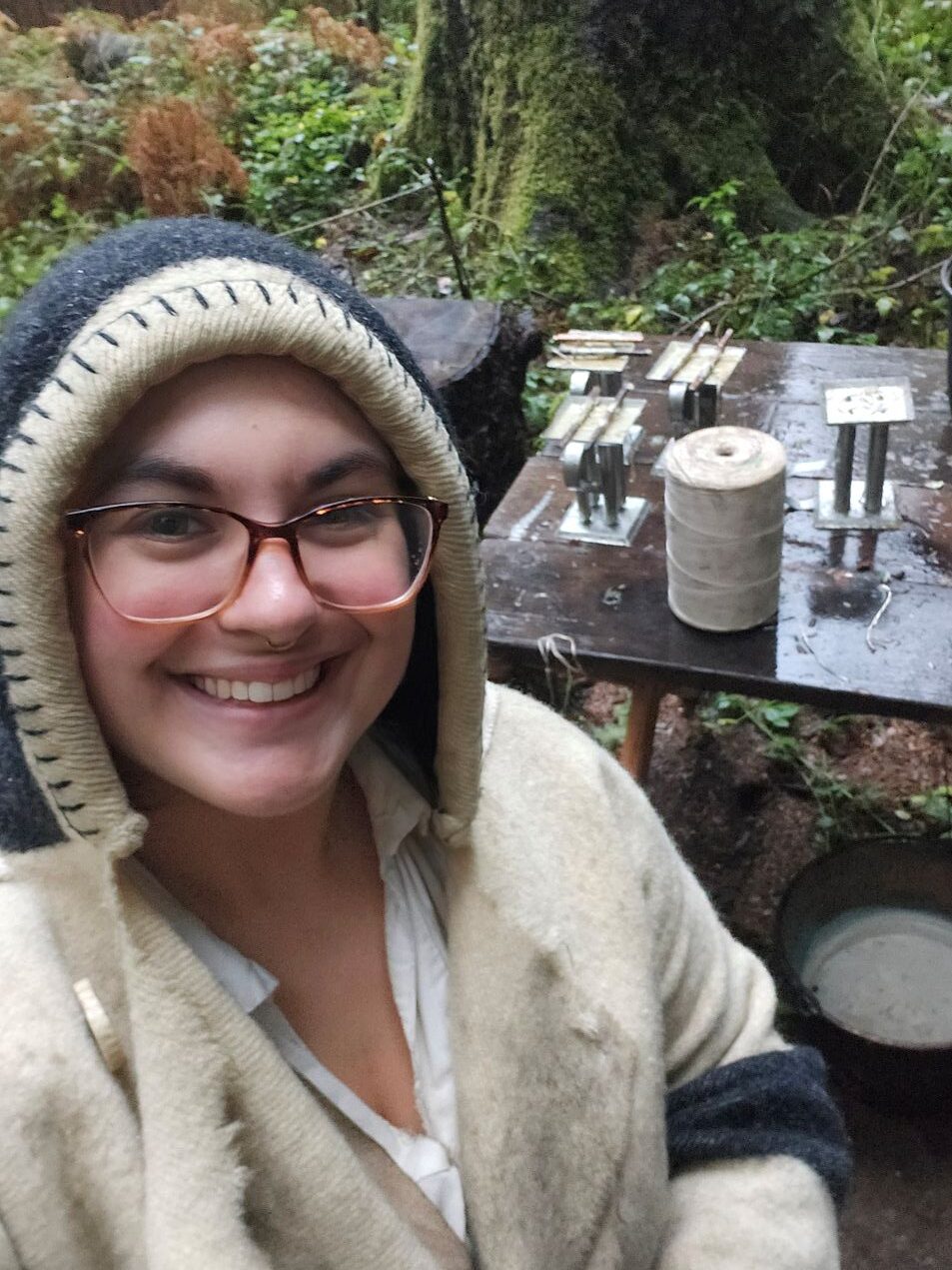 "In this photo, I was demonstrating how the Corps of Discovery would have made candles at Fort Clatsop. We rendered beef fat with paraffin over a fire, poured it into historically accurate molds brought by the expedition, and used Western Red Cedar sticks to hold the wick upright. During this process, I answered visitor questions and invited them to participate in certain steps." - Isabella C. - 
Interpretation and Education intern (AmeriCorps Member) - Lewis and Clark National Historic Park