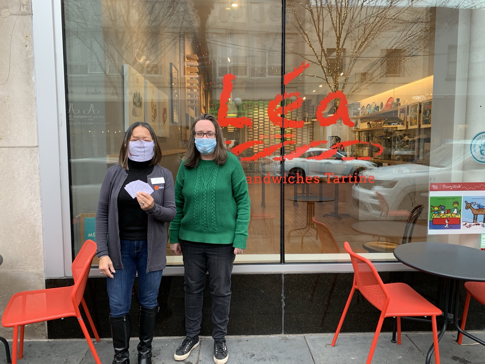 Susie Goldschmidt poses with Colleen Caulliez, co-owner of Lea French Street Food in Oak Park after purchasing gift cards on behalf of Byline Bank.