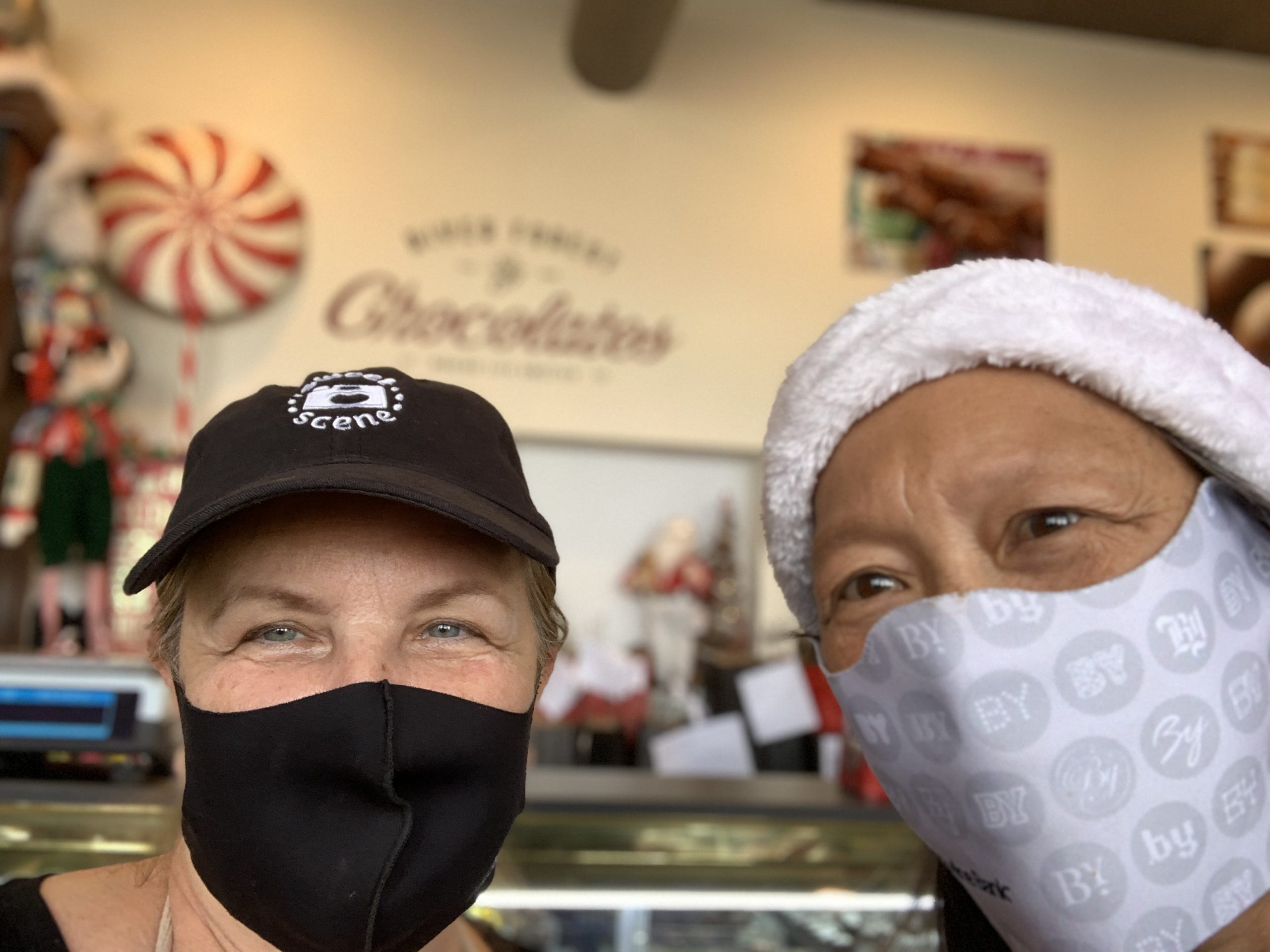 Donna Fantetti-Slepicka. owner of River Forest Chocolates, is all smiles under her mask after a gift card purchase made by Susie Goldschmidt.