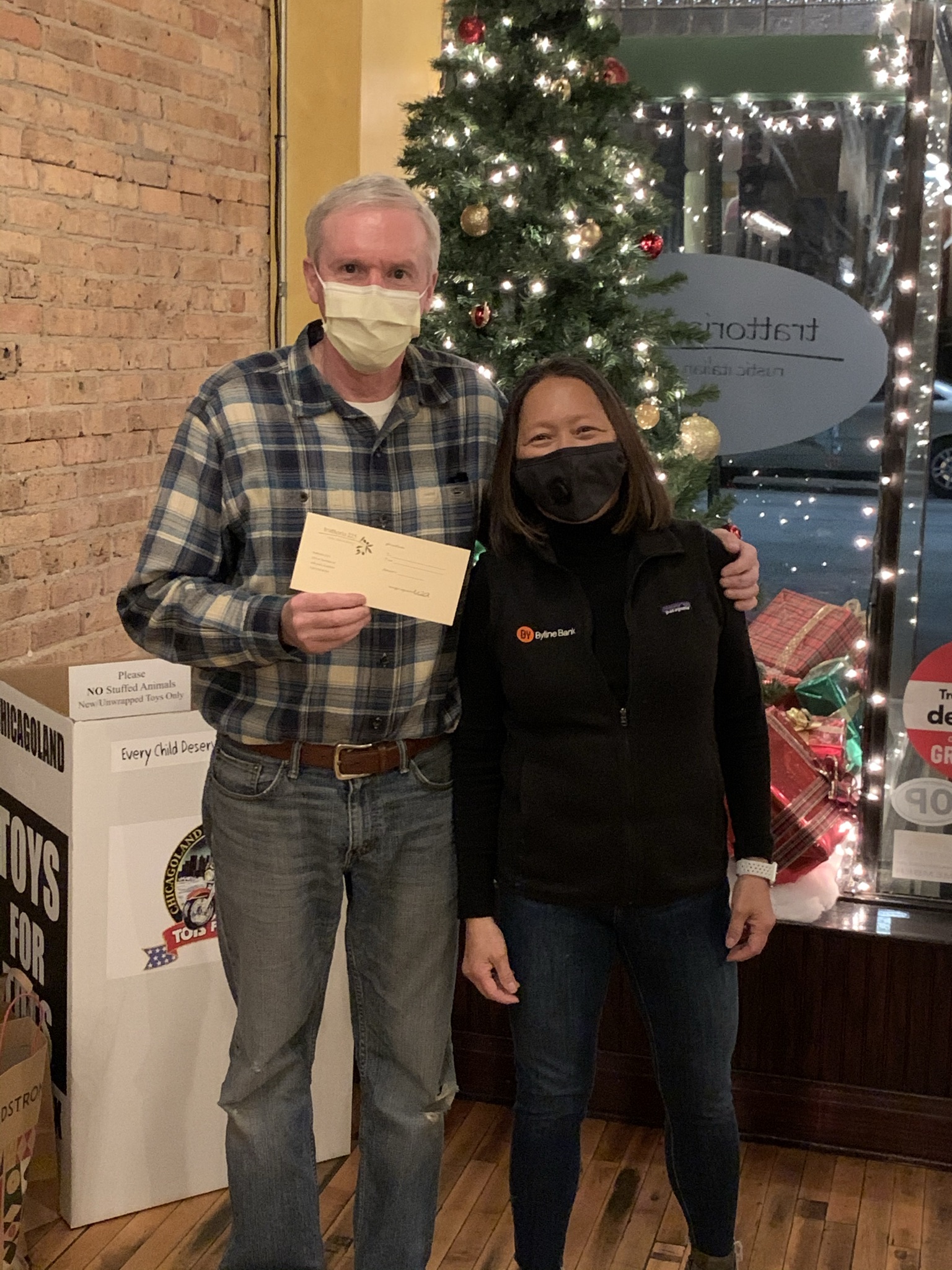 William Quick, owner of Trattoria 225, poses with Susie Goldschmidt after a purchase on behalf of Byline Bank.