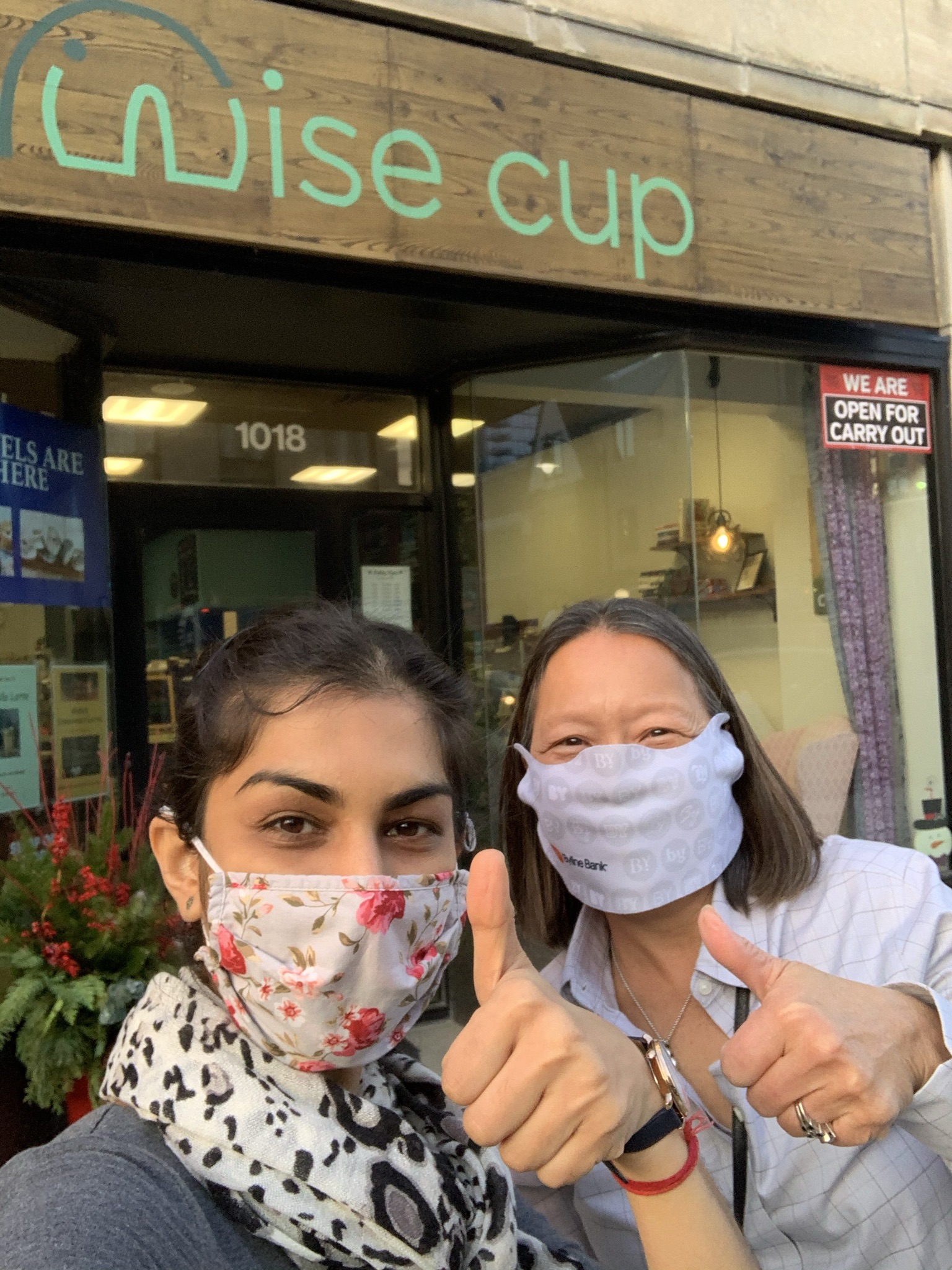 Shivangi Khetarpal, co-owner of Wise Cup, give a thumbs up alongside Susie Goldschmidt of Byline Bank.