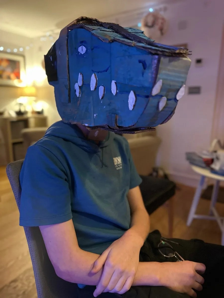 A player in a painted cardboard mask.