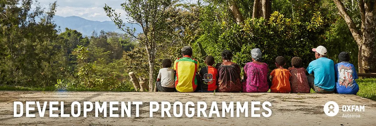 A group of people sit together with text 'development programmes'