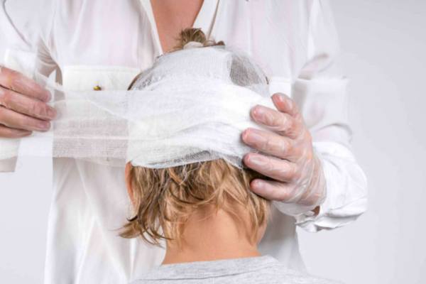 Doctor bandaging a patient's head