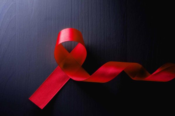 AIDS red ribbon on a dark background