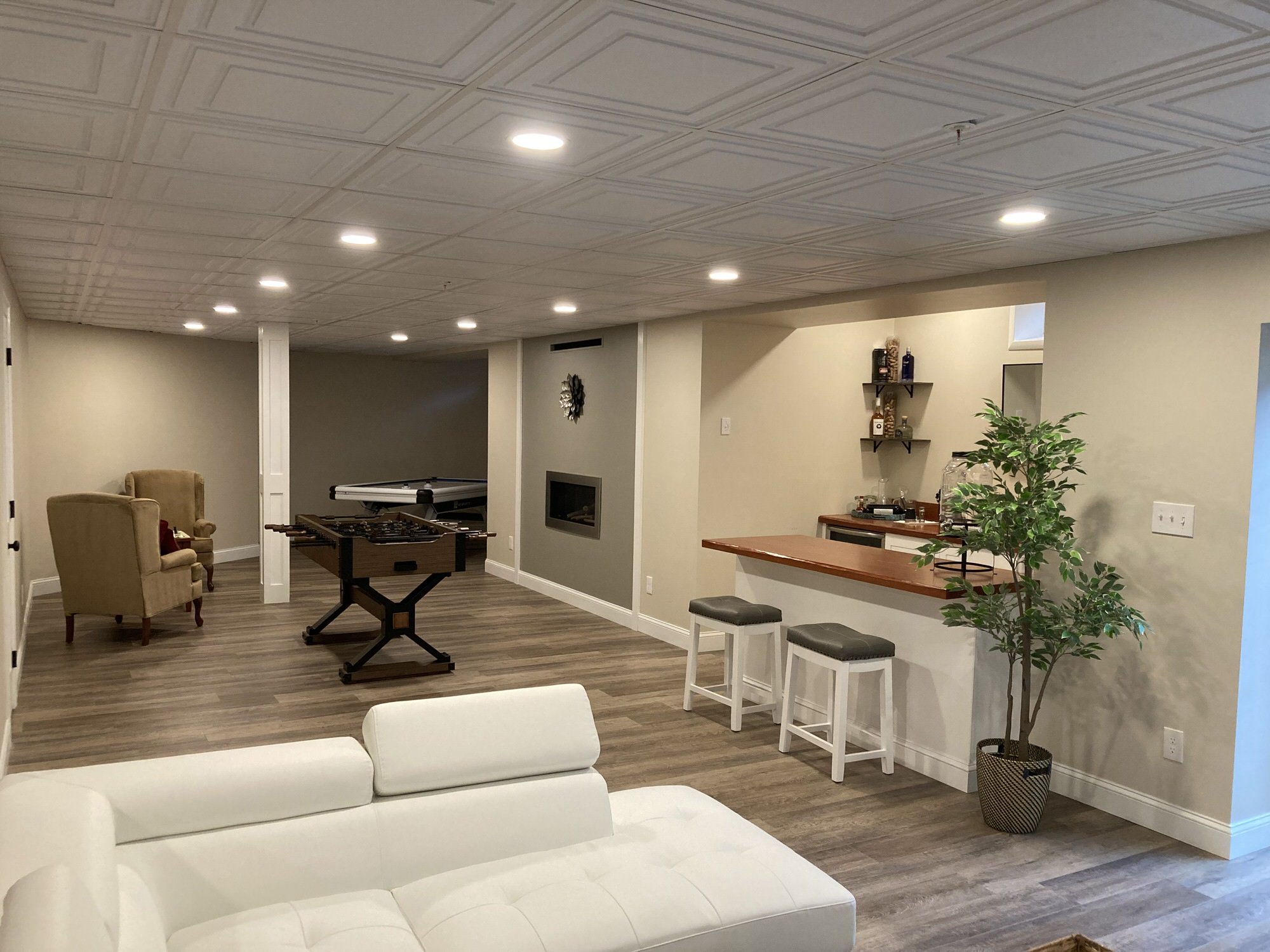 "Basement Renovation with Modern White Leather Couch and Bar, from pdkcontracting.com:"