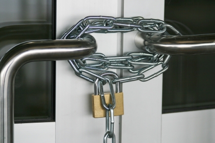 Padlock and chain on a door.