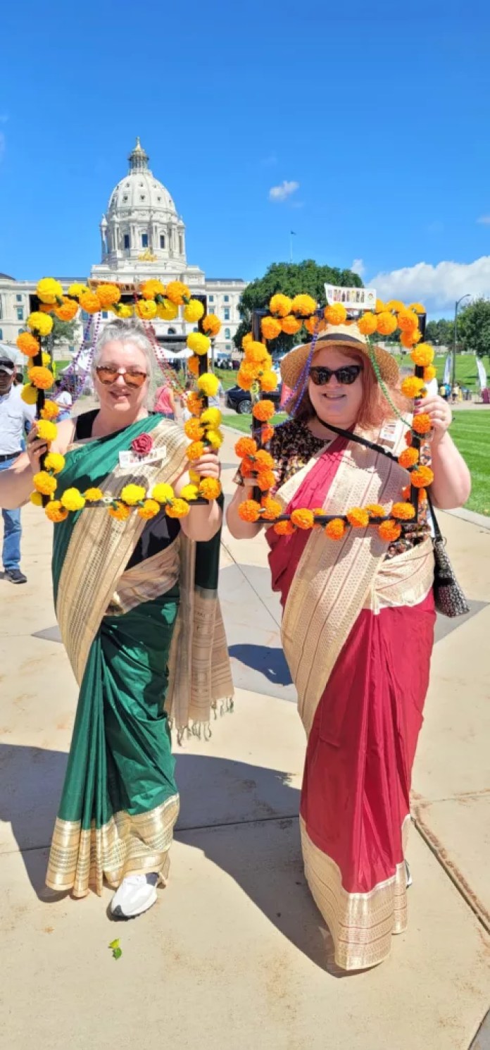 Two Caucasian women experiencing saree for the first time