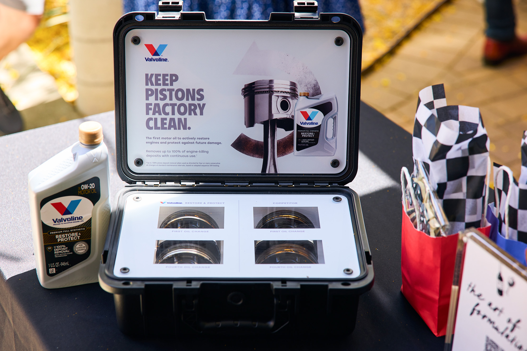 A pro shoot picture of the Valvoline Restore & Protect pistons display box at the entrance to the Sonoma Art of Formulation wine blending bootcamp and engine oil seminar