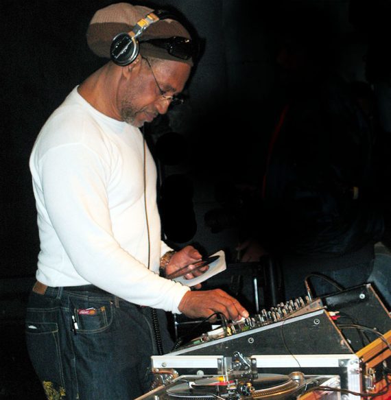 Photo of DJ Kool spinning records. Photo of DJ Kool spinning records.
