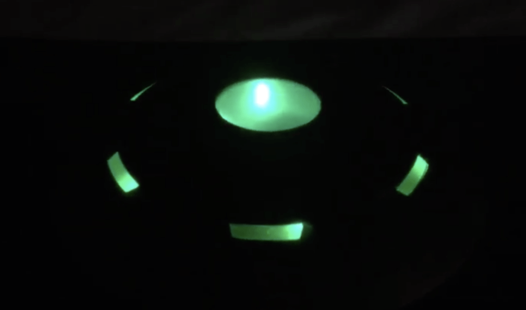 black background with eerie UFO shape made with LED lighting