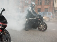 Motorcycle rider with helmet, smoking back tire