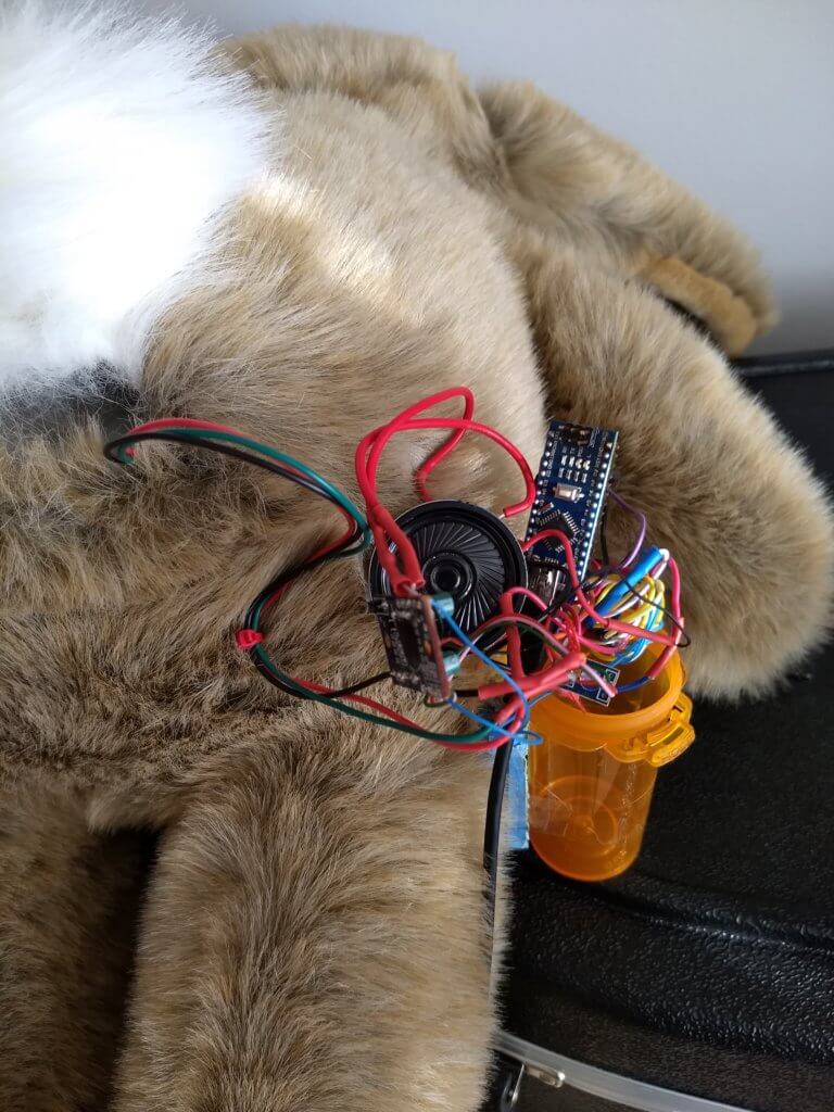 Arduino Nano, speakers and wires coming out of stuffed rabbit behind