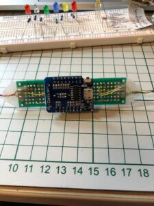 Wifi enabled Arduino on perfboard, and breadboard in background