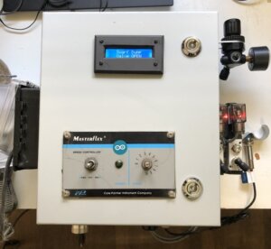 control box with LCD display. One switch and a potentiometer. Arduino sticker on front.