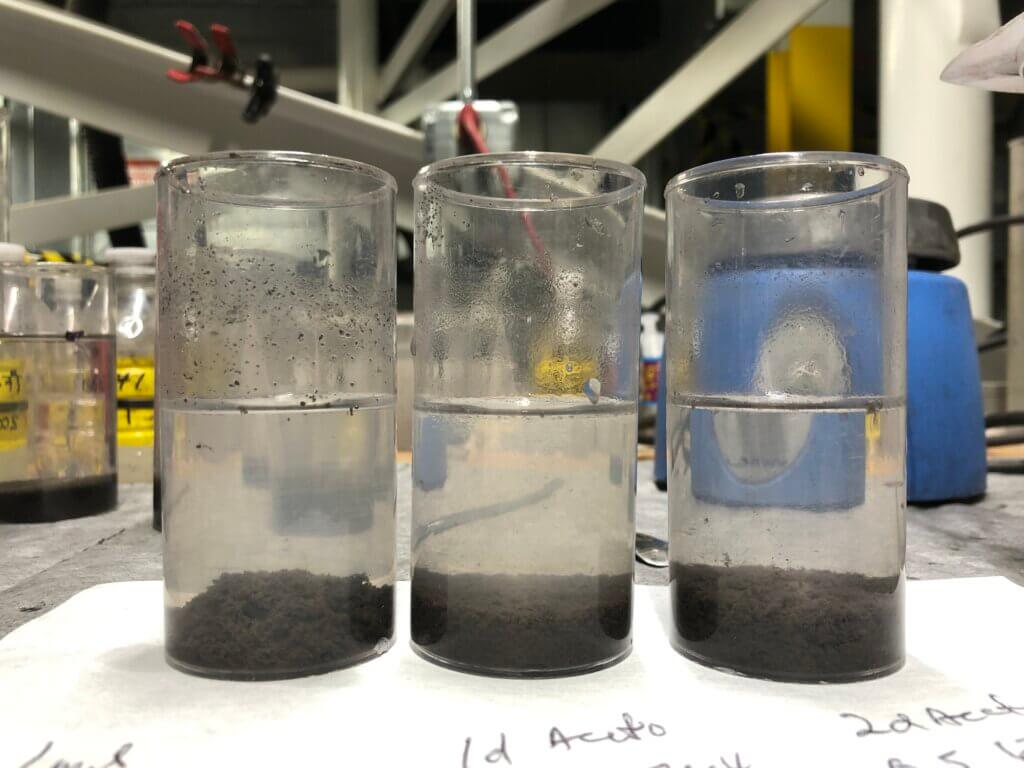 3 clear large glass vials with water logged swarf