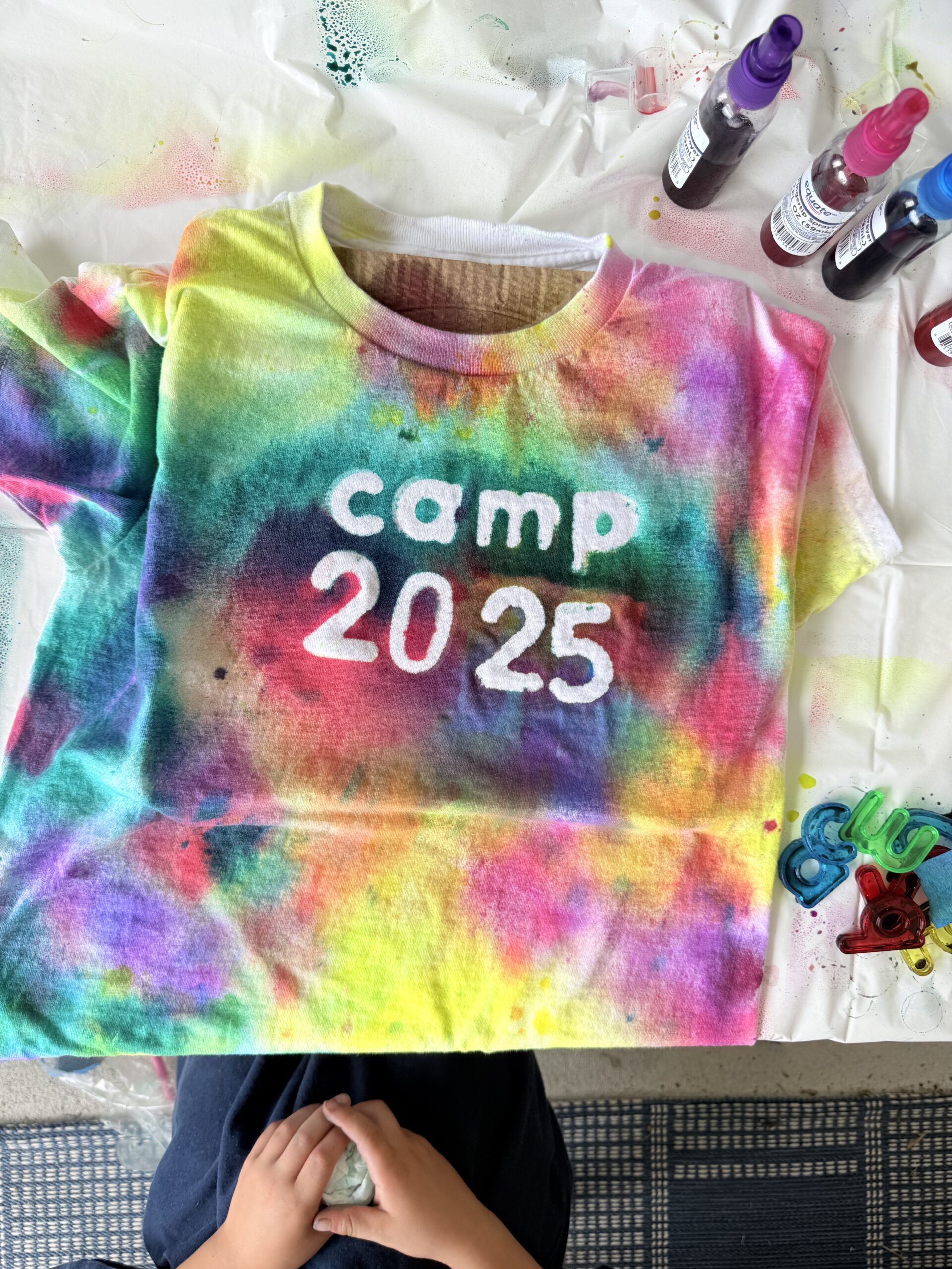 Preschooler creating tie dye shirt with bold colors and minimal mess
