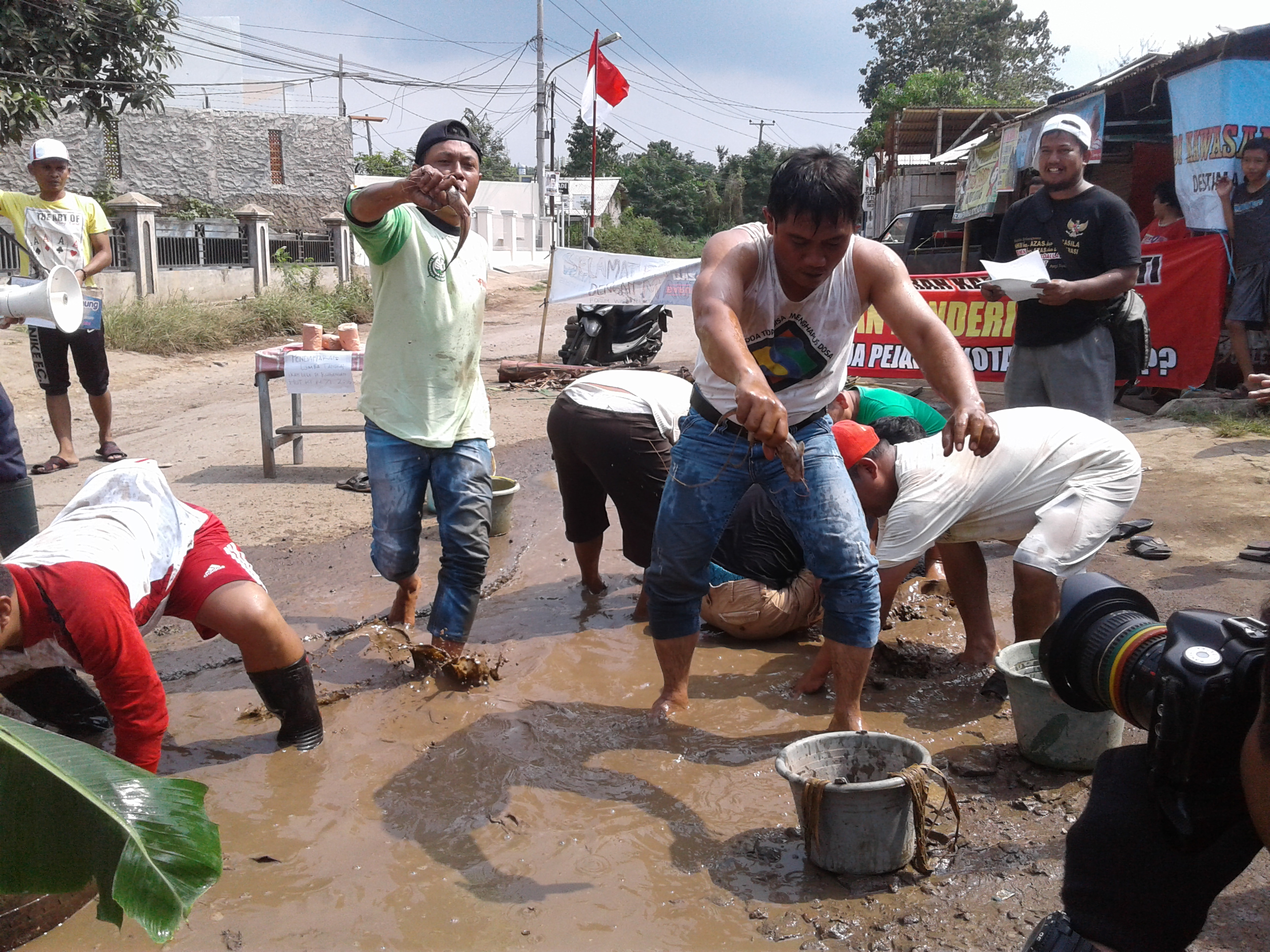 Agustusan, Warga Sepang Lomba Tangkap Lele di Jalan Berlubang