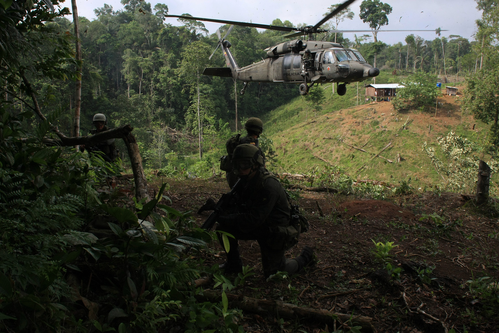 Colombian troops stand on guard after burning a coca laboratory near Tumaco, Colombia, in the southwest state of Narino, June,8, 2008, According to the Police nearly 30,000 hectares (75,000 acres) of coca fields have been fumigated and more than 130 laboratories destroyed in the south of the country since January. Colombia produces most of the world's cocaine. (AP Photo/William Fernando Martinez)