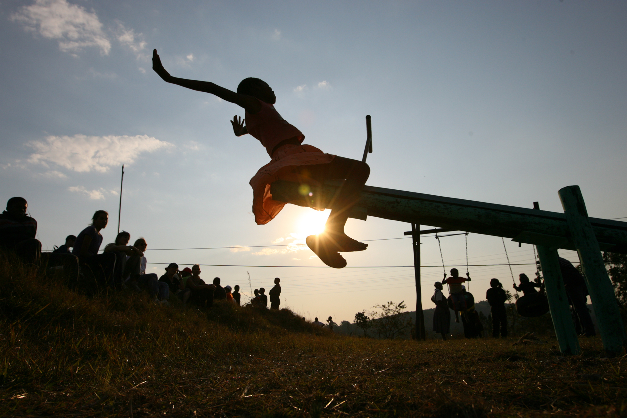 A young girl tests out a new seesaw on a playground built by the Elizabeth Glaser Pediatric AIDS Foundation at the Mkhulamini Clinic in Swaziland