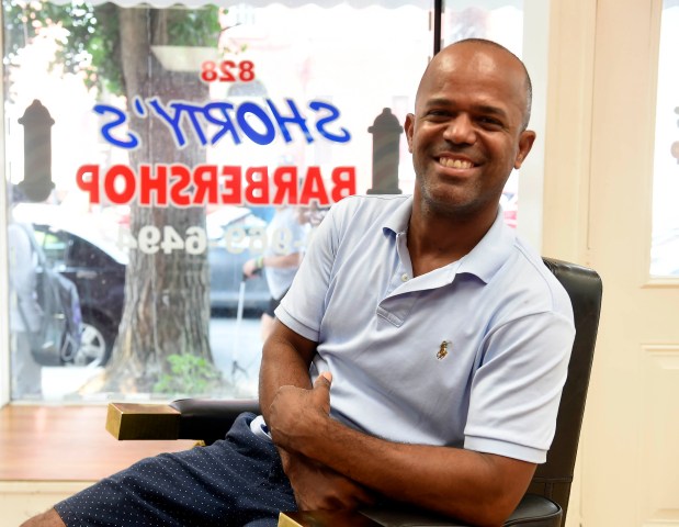 Robert Henriquez, owner of Shorty's Barbershop, has been helping with the cleanup efforts in the 800 block of Chestnut Street. (BILL UHRICH - READING EAGLE)
