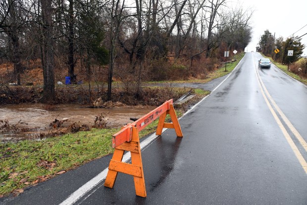 Localized flooding caused by heavy overnight rains prompted a two-hour delay in the Exeter School District on Monday. Portions of Schoffer's Road at Walnut Road were closed earlier due to high water. (BILL UHRICH - READING EAGLE)