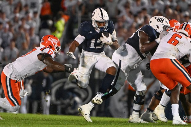 Penn State running back Kaytron Allen breaks a tackle on a third-quarter gain Saturday night against Illinois. (AP Photo/Barry Reeger)