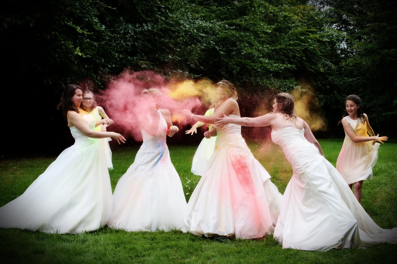 Brides trash their wedding dresses by throwing paint over each other