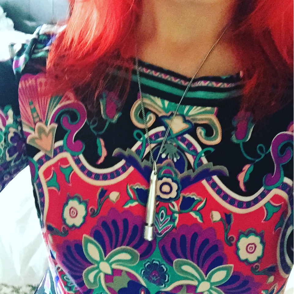 Necklace made from a Doxy massager charm on a chain.