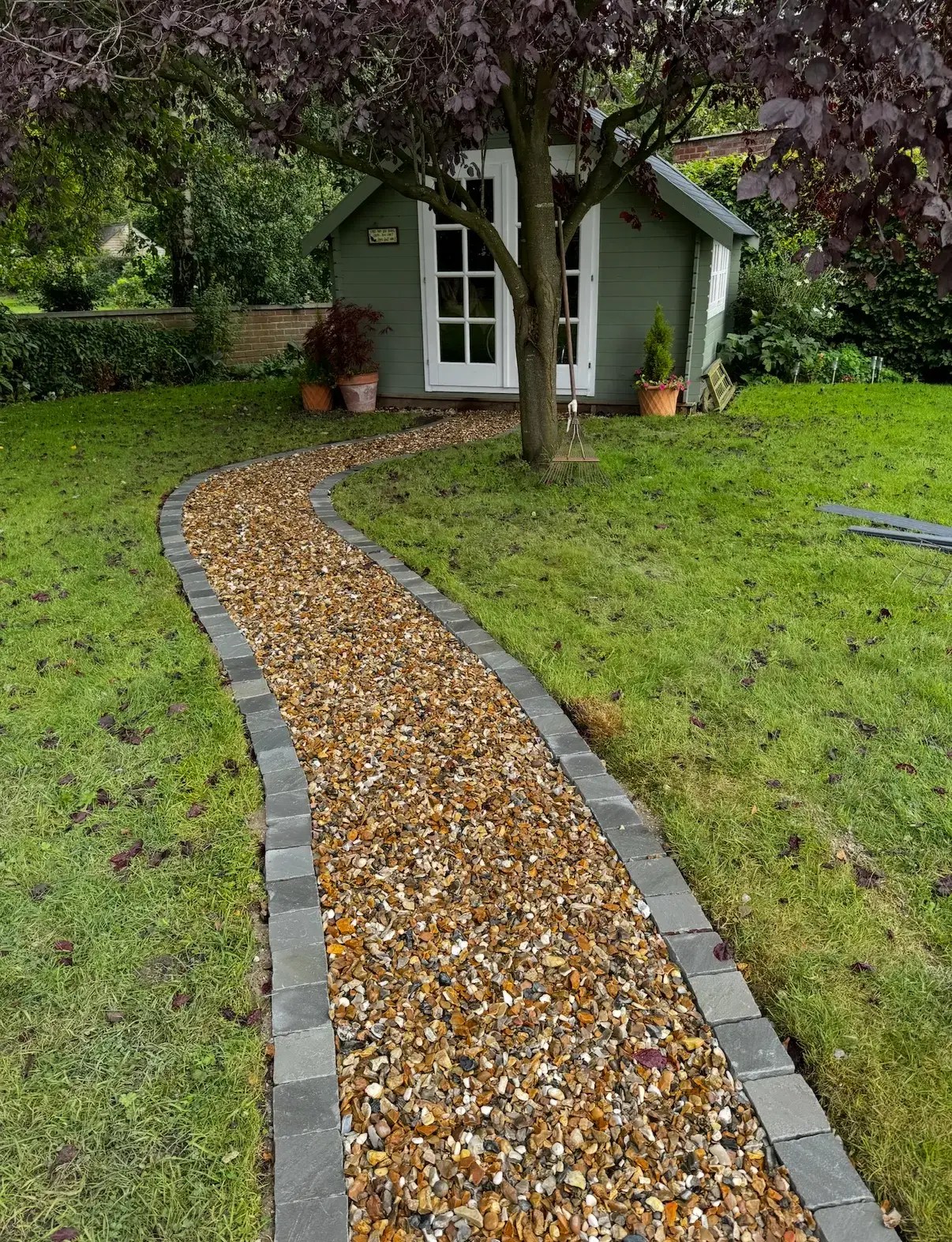Landscape gardeners in Gainsborough creating curved gravel garden path with block edging
