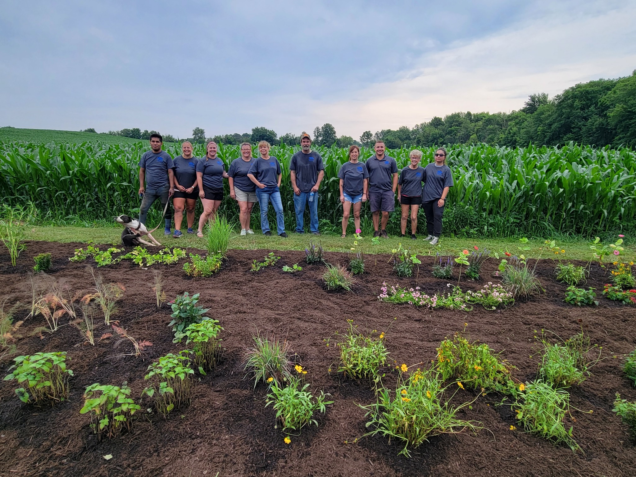 People standing in front of a garden