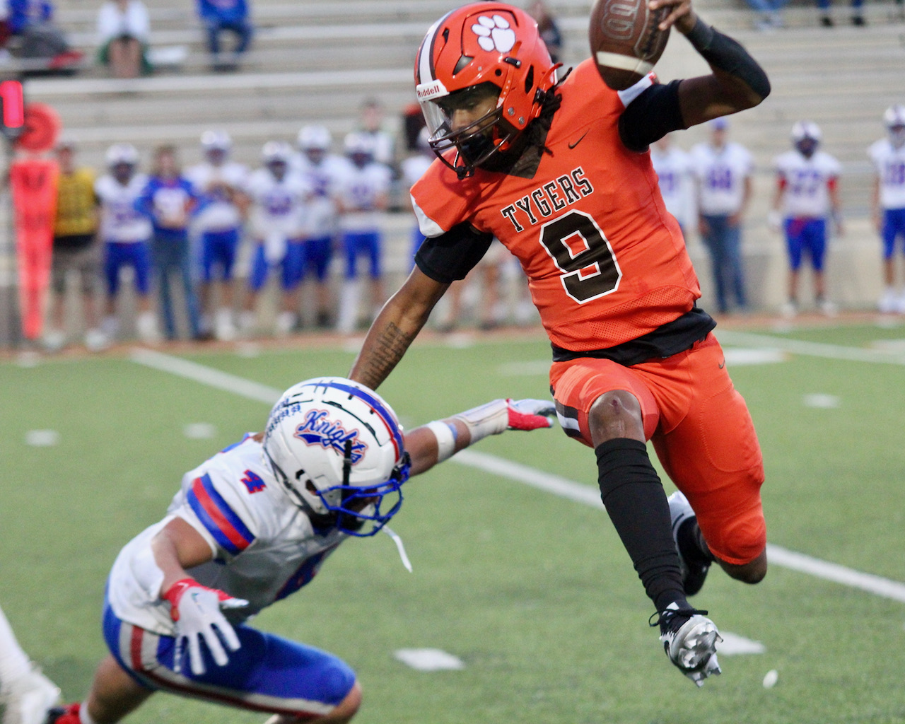 Mansfield Senior quarterback Duke Reese avoids West Holmes' Gus Warner during Friday's Ohio Cardinal Conference game at Arlin Field.