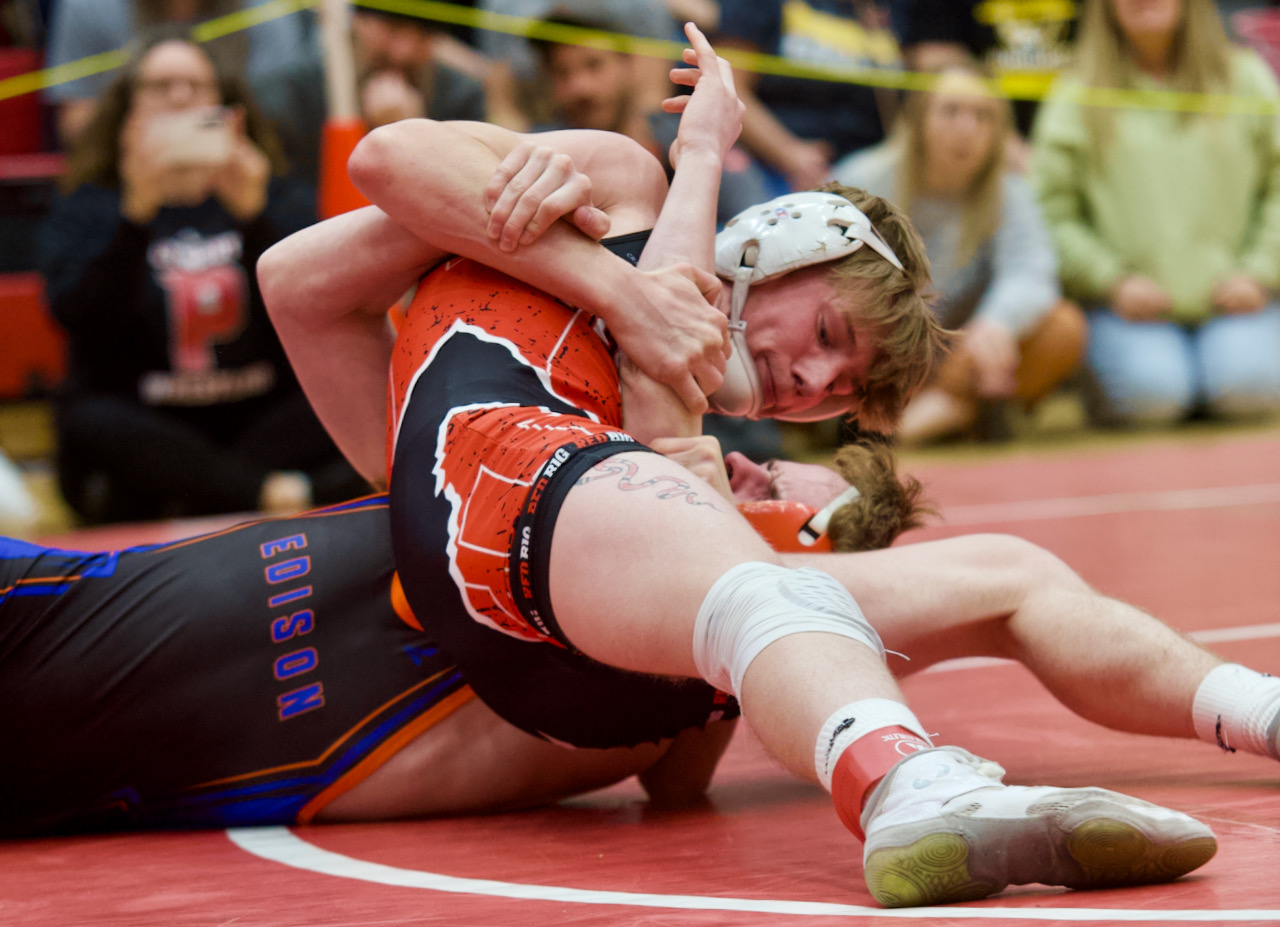 A wrestler pins an opponent
