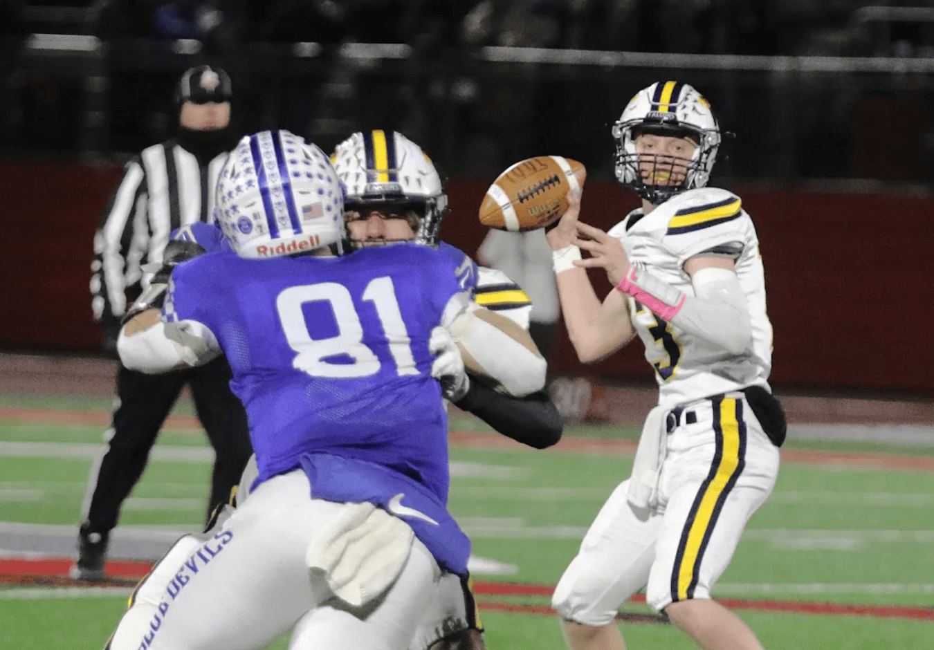 A quarterback looks for an open receiver