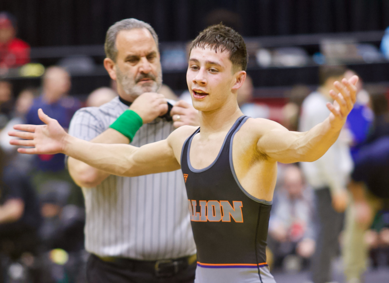A wrestler celebrates his victory